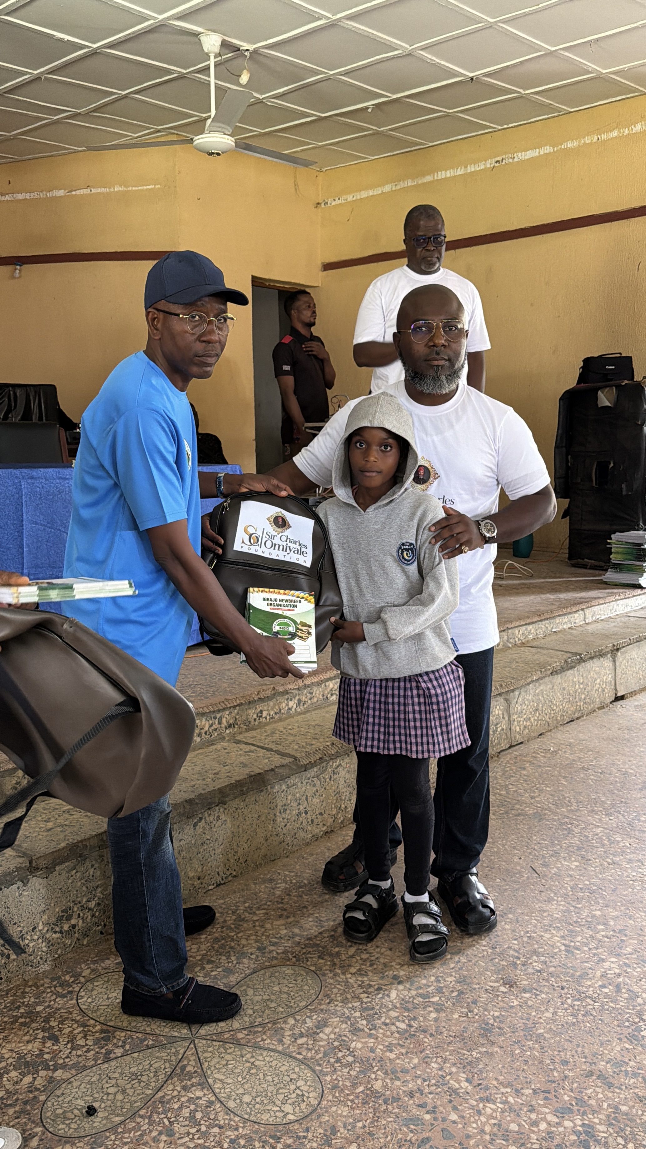 Sir Charles Omiyale donating school supplies alongside the acting President of Modern Igbajo Development League in Osun state